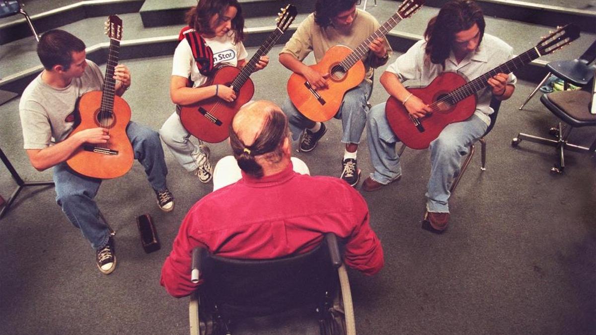 Miami Beach Sr. High music teacher professor Doug Burris teaches guitar to from left to right Eric Mix, Nicole Chaumont, Edgardo Huanilo and Jesse Cieslicki Thursday june 4, 1998
