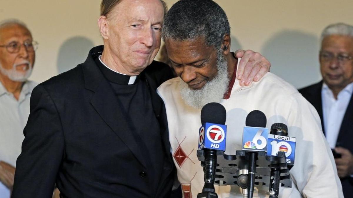 The Rev. Patrick H. O'Neill, a Catholic priest, embraces Muslim Imam Khalid A. Salahuddin during an interfaith clergy dialogue at Friends Meeting House in South Miami during an MCCJ meeting on Thursday, December 10, 2015