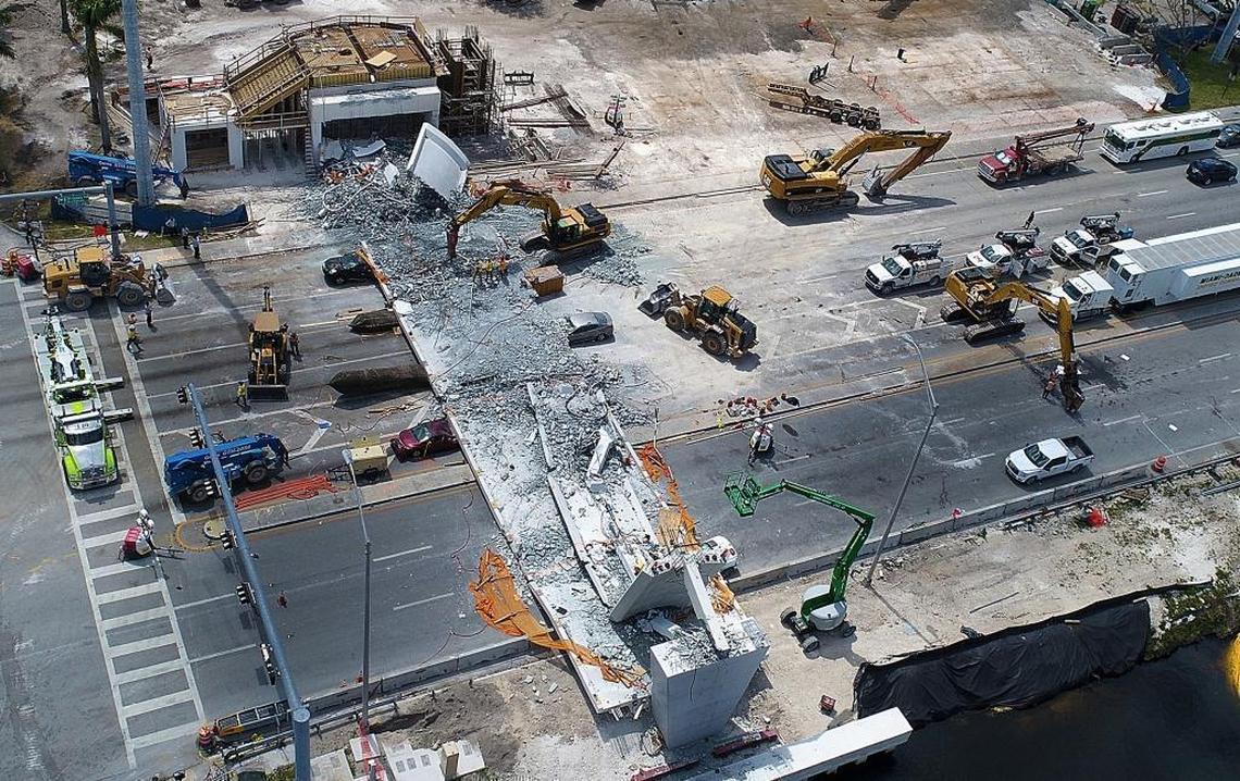 An aerial view shows the Florida International University bridge recovery operations on Saturday, March 17, 2018. The wine-colored car driven by Emily Joy Panagos, its trunk crushed, is to the left of the fallen span, near the center of the frame.