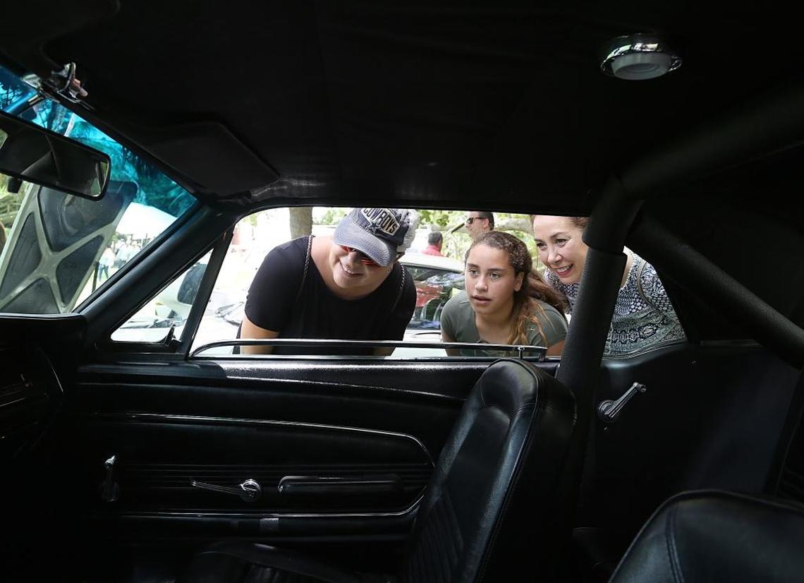 Catalina Herzog, 43, left, Madison McDonald, 13, center, and mother, Christina McDonald, 49, check out the interior of a 1967 Ford Mustang. The Barnacle Historic State Park held its Father’s Day celebration called “Cars and Cigars” on Sunday, June 18, 2017.