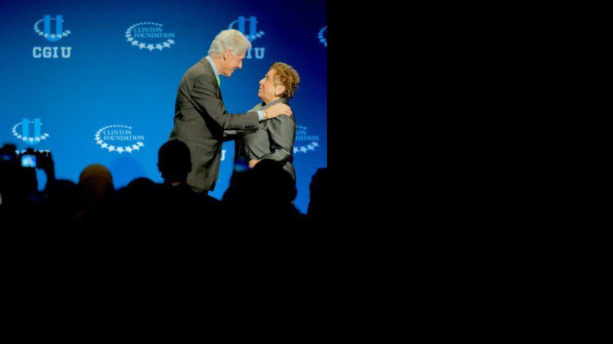 
President Bill Clinton, left, hugs University of Miami President Donna Shala at the opening plenary session of the Clinton Global Initiative University at the University of Miami on Friday, March 6. University of Miami Donna Shalala will head the Clinton Foundation after she leaves the University of Miami later this year.
