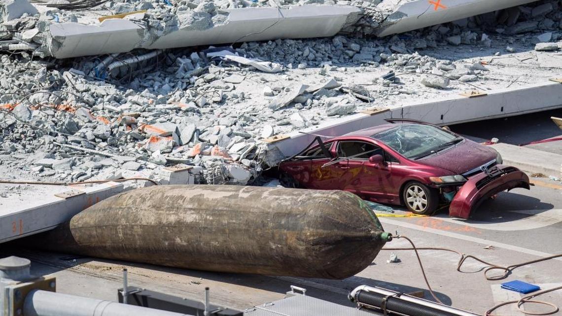 The back end of a red Honda Civic driven by Emily Joy Panagos, an FIU student waiting at the light, was crushed by the fallen bridge. She survived, and filed suit Tuesday.