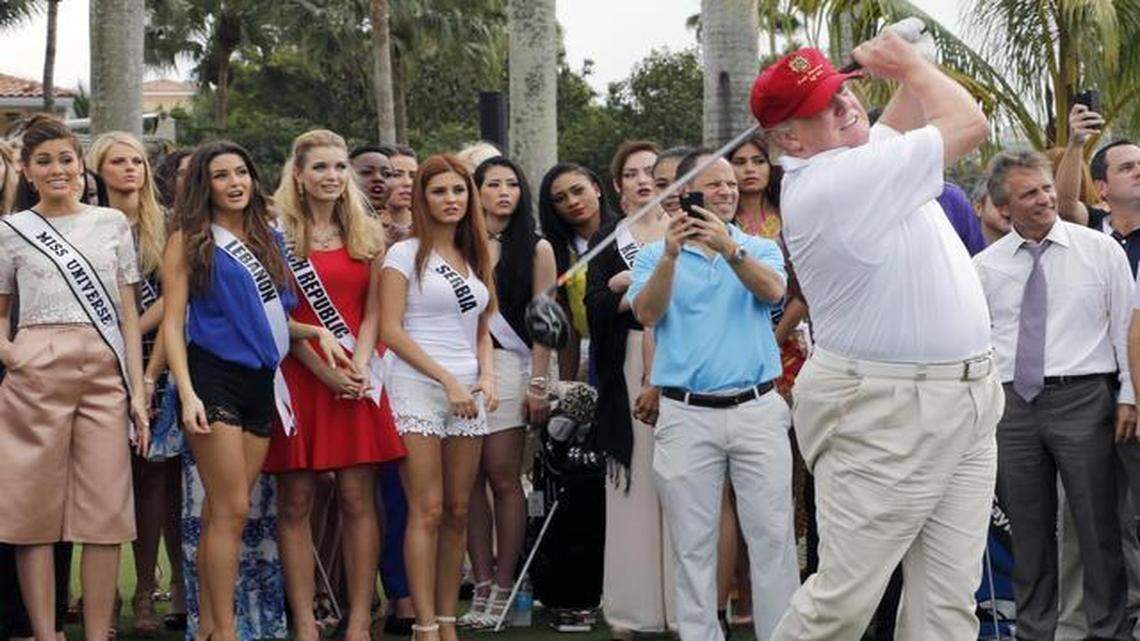 
Donald Trump, right, tees off at the Trump International Doral Miami course as Miss Universe contestants watch on Jan. 12, 2015.
