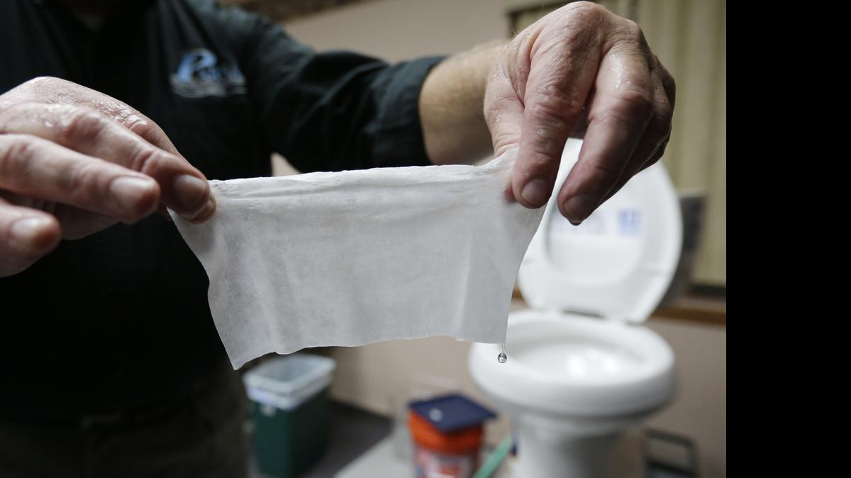 
In this photograph taken, Friday, Sept. 20, 2013, in Middlesex, N.J., Rob Villee, executive director of the Plainfield Area Regional Sewer Authority in New Jersey, holds up a wipe he flushed through his test toilet in his office. Miami-Dade County’s sewer department launched a campaign Tuesday against “flushable wipes,” joining a national effort to keep the popular products out of the toilet. 

