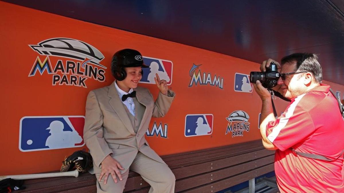 Christopher Buchanan takes a photo of foster kid William at Marlins Park, Wednesday, November 11, 2015. Nearly 40 children gathered in Marlins Park to have their photos taken. The kids are in foster care. The goal is to post portraits of the children online to encourage prospective parents to adopt them.