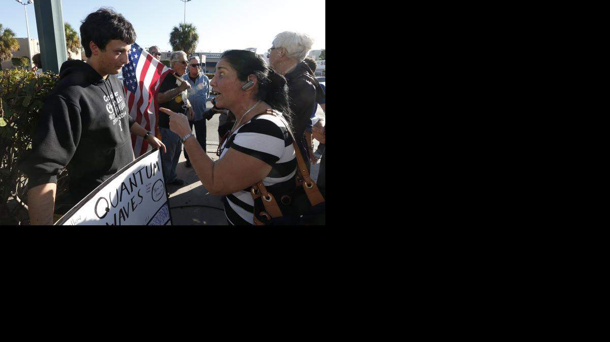
An unidentified woman argues with Bryan Medina regarding Medina's congratulatory sign at Versailles Restaurant in Miami on Wednesday, Dec. 17, 2014 following President Barack Obama's announcement that the U.S. will normalize relations with Cuba.
