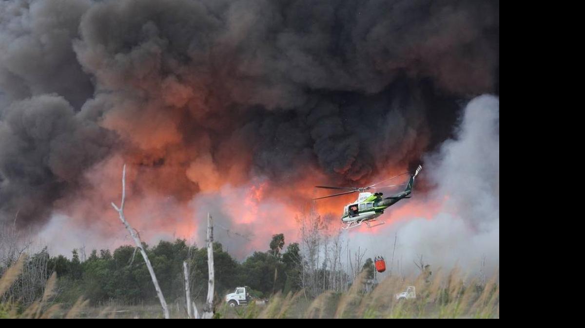 
Fire crews battle a large brush fire in Southwest Miami-Dade on Sunday, April 19, 2015. 
