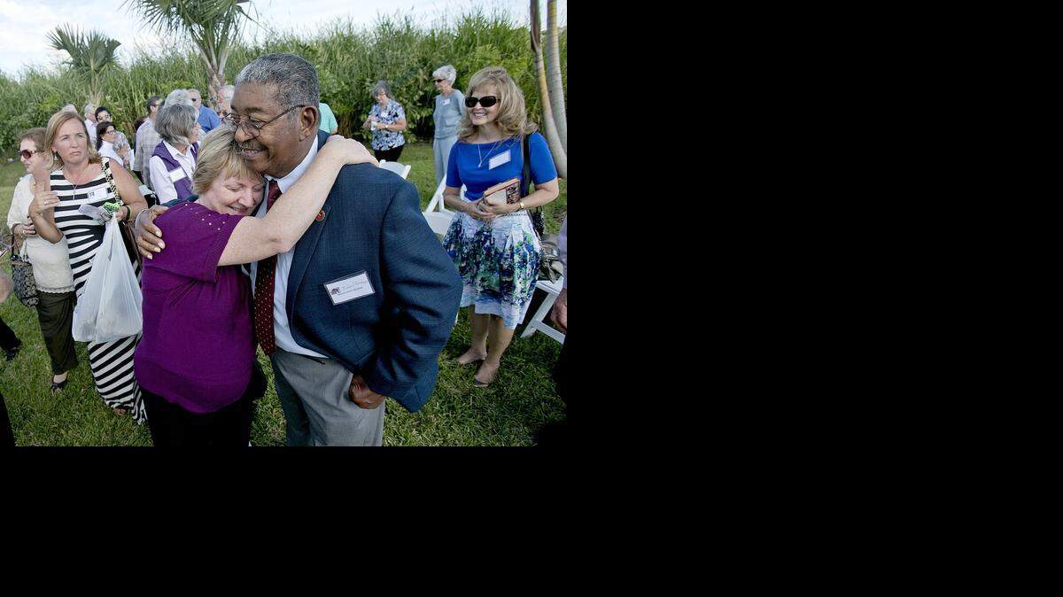 
Ruth Reynard, art left, gets a hug from by Juan Tamayo on Sunday November 16, 2014 outside the Vista Lago Ballroom in South Miami-Dade. Ruth was 4 years old when she was rescued by Tamayo after her family had been taken hostage by Congolese guerrillas and rescued by Cubans working for the CIA.
