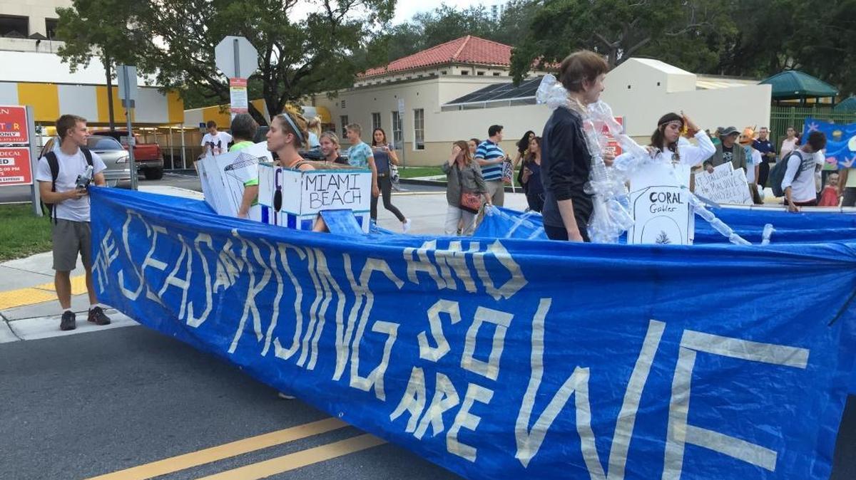 
The participants of Wednesday’s climate change march in Miami created a number of installations. One group, Urban Paradise Guild, mimed the sea-level rise drowning Miami.
