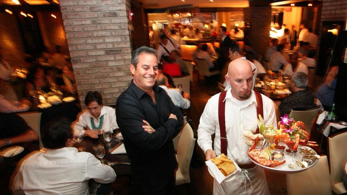 A scene from Prime 112 (and owner Myles Chefetz in black). The restaurant would see a higher food tax if the leader of Miami-Dade’s homeless board succeeds in expanding the county’s homeless tax to Miami Beach and two other coastal cities.