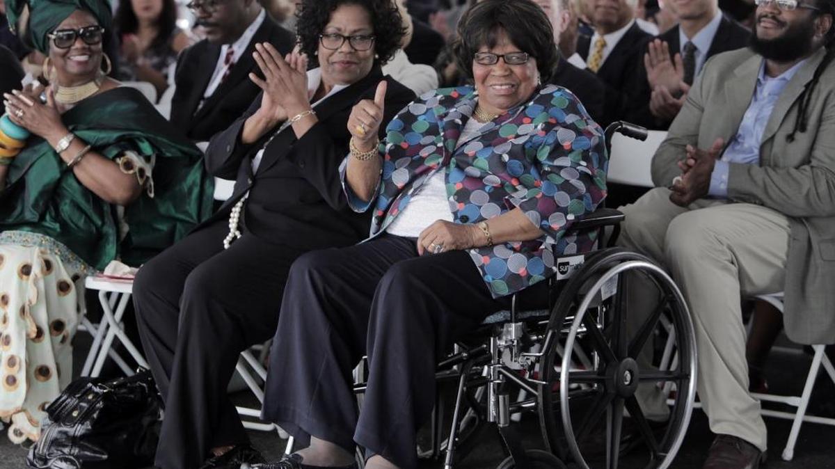 Carrie Meek gives thumbs up as guests recognize her during the groundbreaking for the Carrie Meek Foundation’s new Amazon warehouse at Opa-locka airport. To her left is her daughter, Lucia Davis-Raiford.