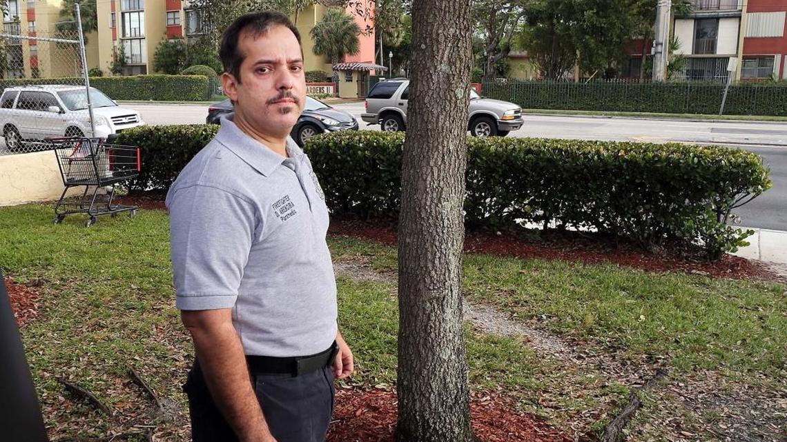 Firefighter David Arencibia, a paramedic with the Miami-Dade Fire Rescue Department, stands across the street from a building where he rescued a 6-year-old girl by pulling her out through a window from an apartment located at 9400 Flagler St. on Thursday night, Feb. 18, 2016.