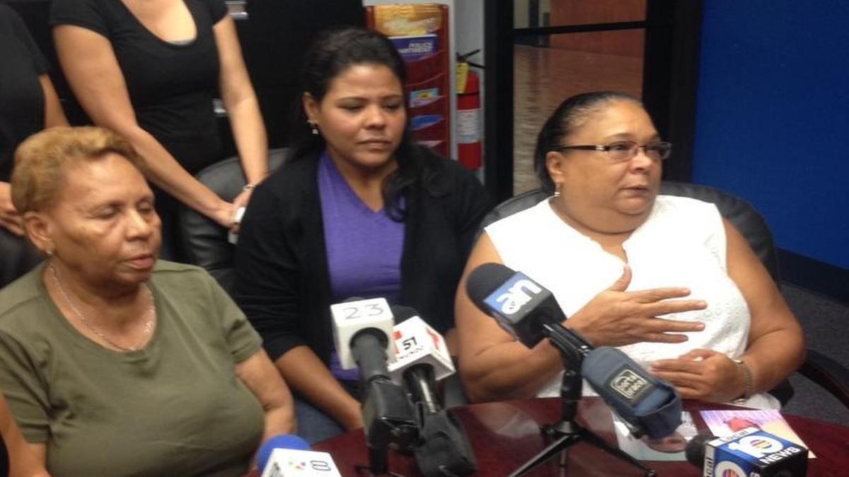 
Jose Ceruto’s mother, Josefa Rodriguez, bottom left, surrounded by family at Miami police headquarters on Friday, discusses her son’s death.
