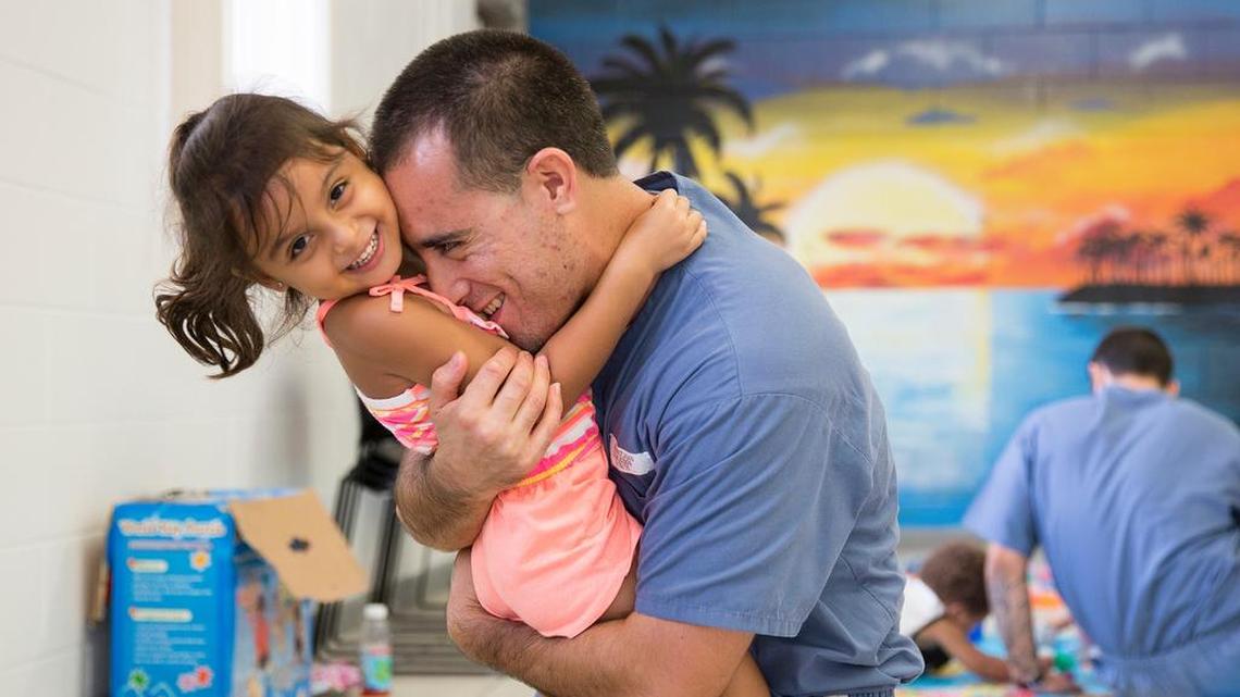 Jean Ramirez, 30, plays with his daughter Mia Victoria Ramirez, 4, at Everglades Correctional Institution on Wednesday, July 15, 2015. Children of Inmates, Inc. and the Florida Department of Corrections arranged for children to reconnect with their incarcerated fathers at Everglades Re-Entry Center for about three hours for board games and lunch.