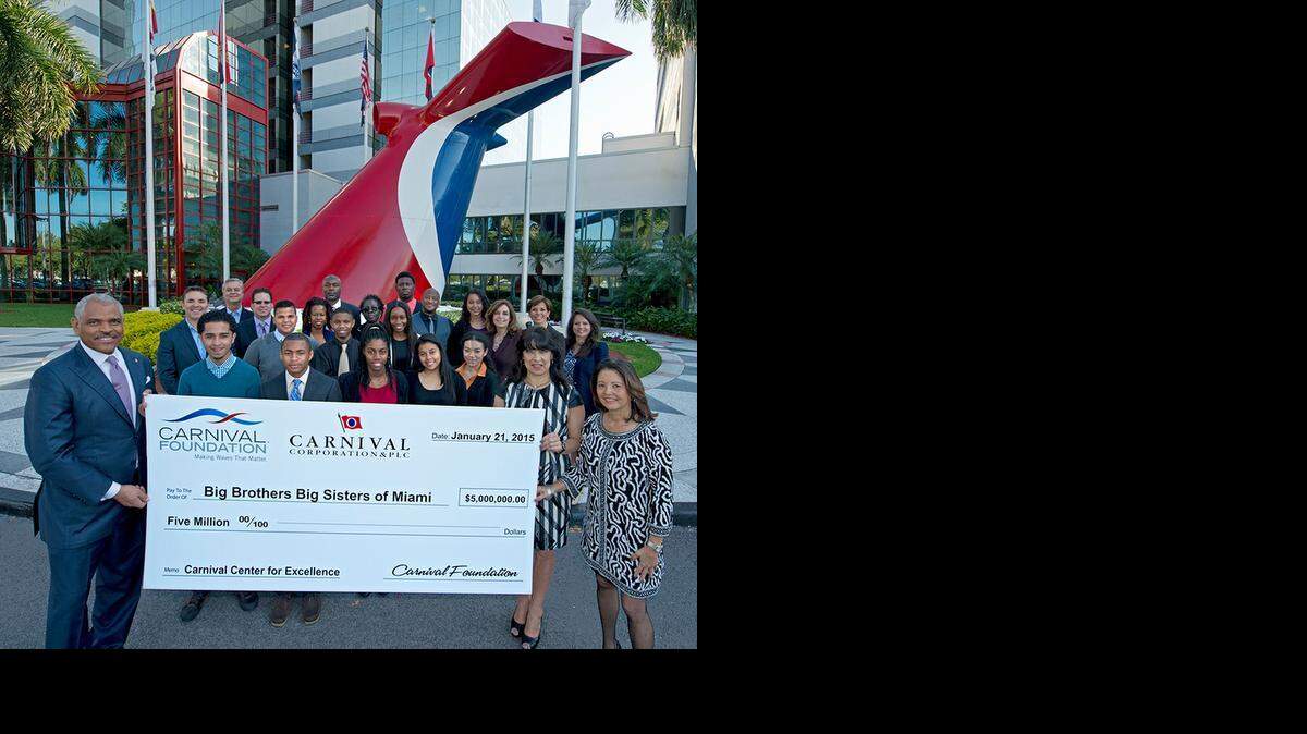 
Arnold Donald, left, president and CEO of Carnival Corporation, and Linda Coll, director of Carnival Foundation, second from right, present Lydia Muniz, right, president and CEO of Big Brothers Big Sisters of Miami, a $5 million donation to create the Carnival Center for Excellence. The event took place Wednesday at Carnival's Doral headquarters. Mentors and students who participate in Carnival's school-to-work program also attended. 
