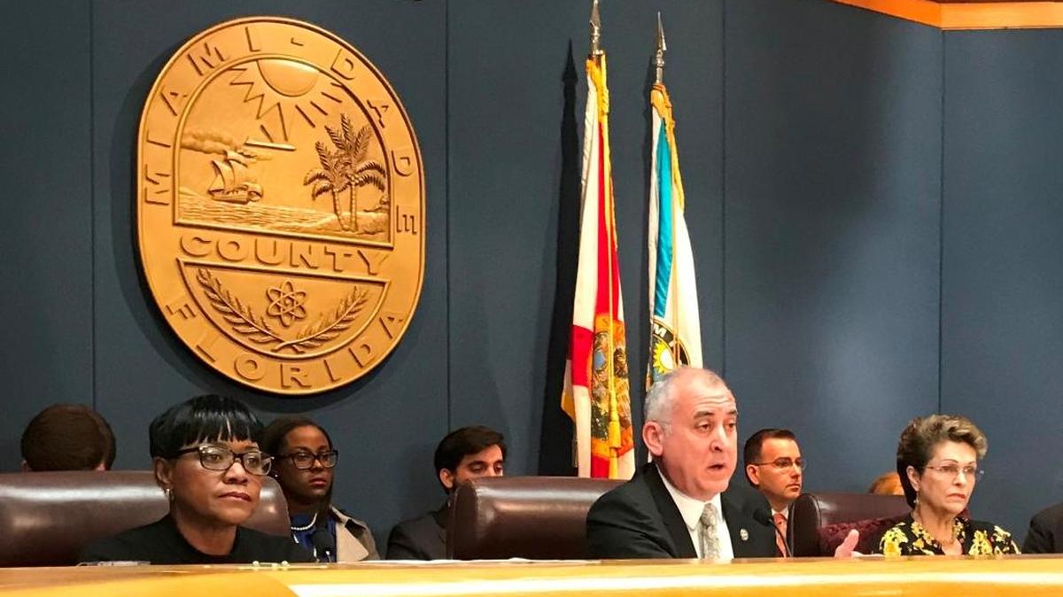 Esteban “Steve” Bovo, chairman of the Miami-Dade County Commission, center, sponsored an amendment that changed the county’s policy on urging Congress to restore a national ban on assault weapons.