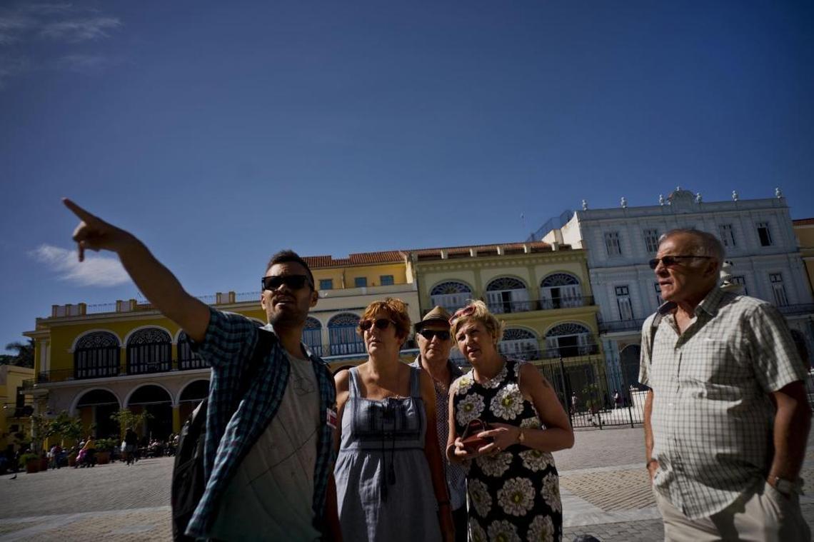 Private tour guide Javier Rodriguez, left, speaks to tourists in Havana, Cuba on Jan. 18, 2018.