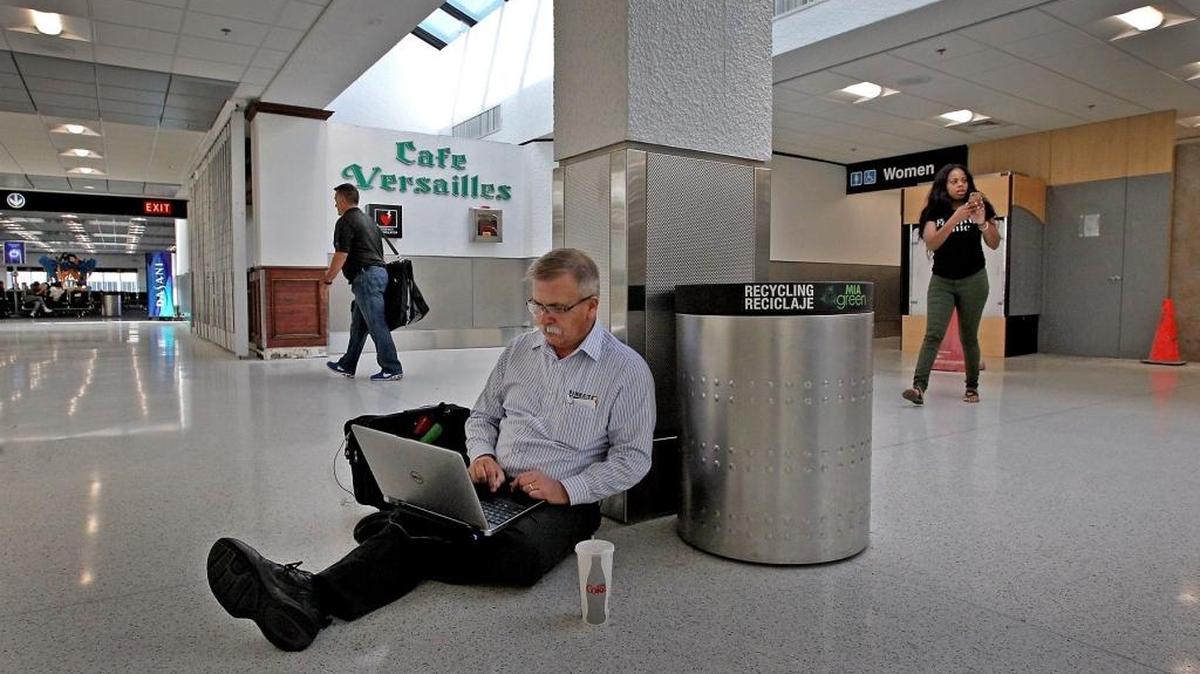 Chuck McCown of Salt Lake City, Utah gets some work done outside a closed Café Versailles in the renovated wing of Concourse E at Miami International Airport while waiting for a flight. McCown went to another terminal to get something to eat.