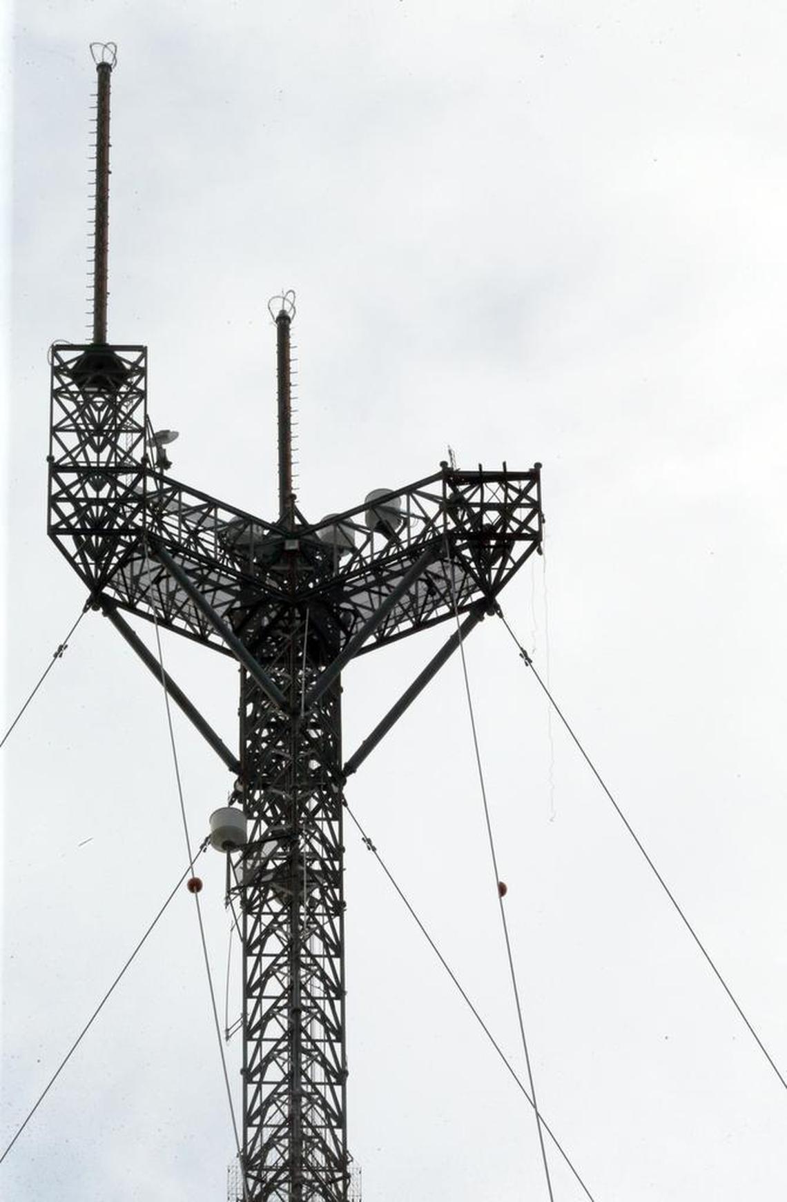 The right side of a TV transmission tower was shorn off when a pole attached to it collapsed on Wednesday, Sept. 26, 2017, killing three men. The tower was more than 1,000 feet high and the men were near the top of the tower, authorities said.