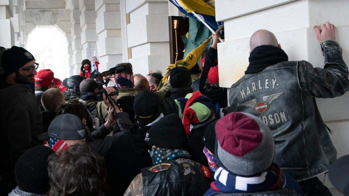 On Jan. 6, insurrectionists loyal to President Donald Trump try to open a door of the U.S. Capitol as they riot in Washington. At least a dozen of the 400 people charged so far in the Jan. 6 insurrection have made dubious claims about their encounters with officers at the Capitol. “With television and other media, the world is able to watch history unfold right before our eyes,” observes Bea L. Hines.