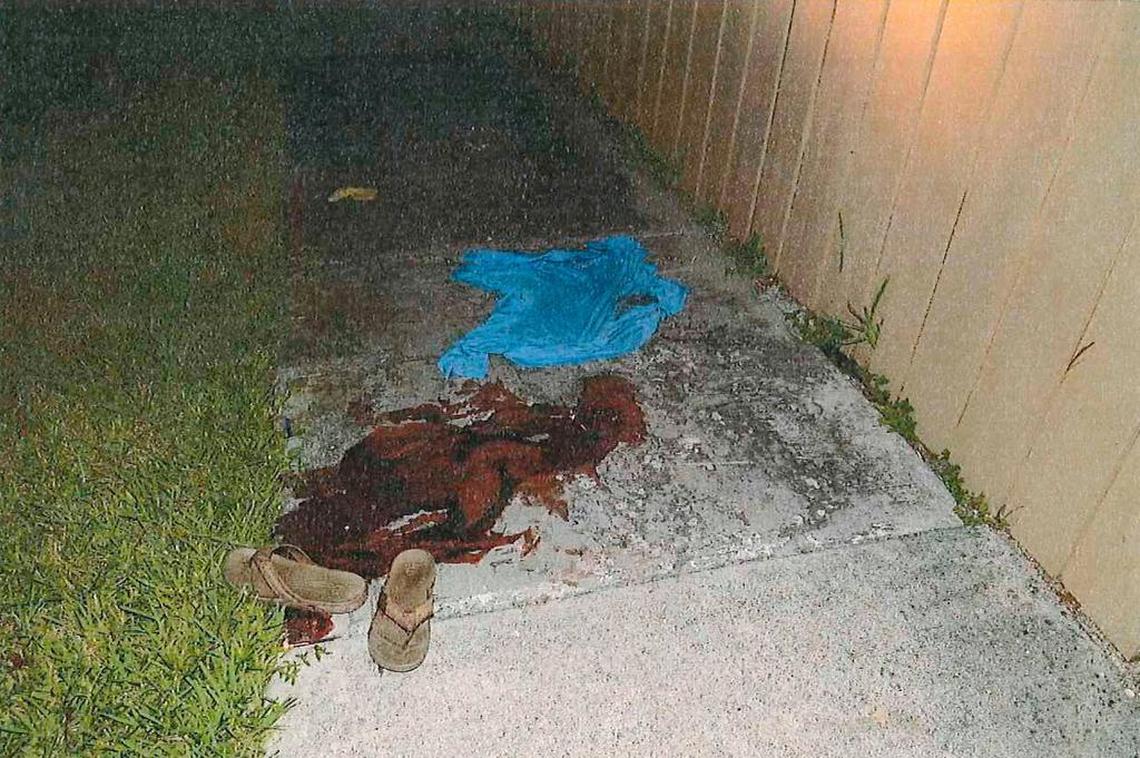 Blood stains a sidewalk after a shooting in the Village of Kendale. Omar Rodriguez faces an attempted murder charge after a shooting that began with a confrontation over dog poop on a lawn.