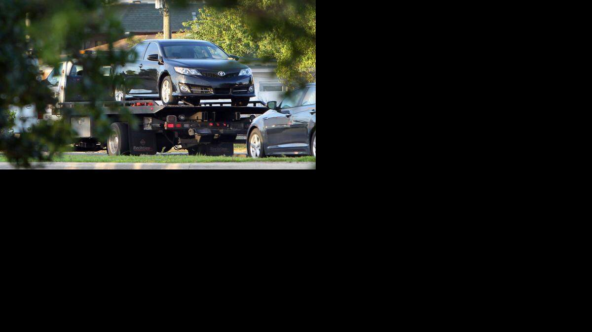 
A shooting outside a Miami Gardens Checkers restaurant has left a father of three dead as his vehicle is towed away from the scene Wednesday April 15, 2015.

