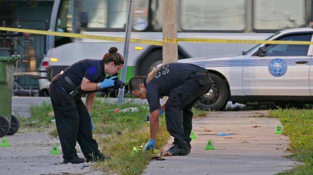 City of Miami Crime Scene investigators scour a shooting scene.