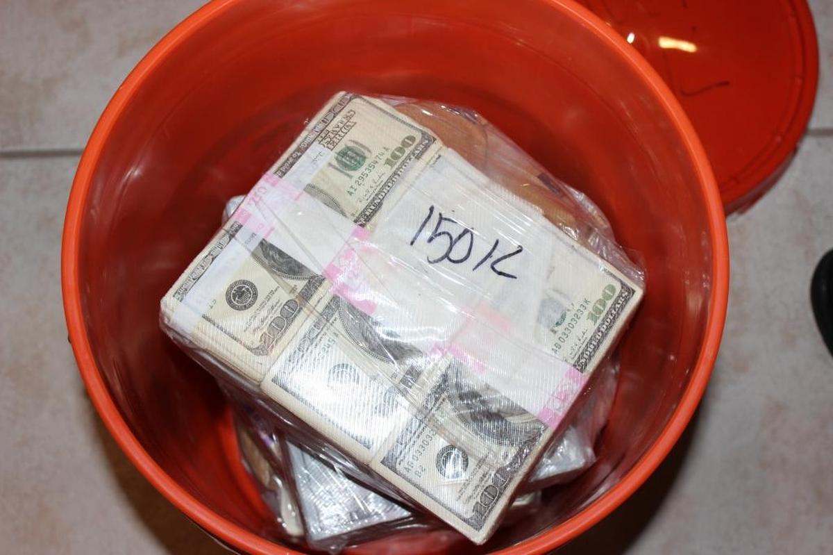 Cash in buckets seized from the Miami Lakes home of Luis Hernandez-Gonzalez. He was charged with money laundering and marijuana trafficking.