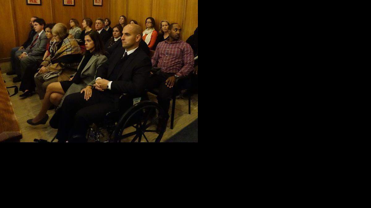 
Coral Gables attorney Henry Hernandez, in a wheelchair, was injured in the hit-and-run crash that killed friend Walter Reyes. Hernandez appeared in court Friday as prosecutors formally charged the suspect, Alejandro Alvarez.
