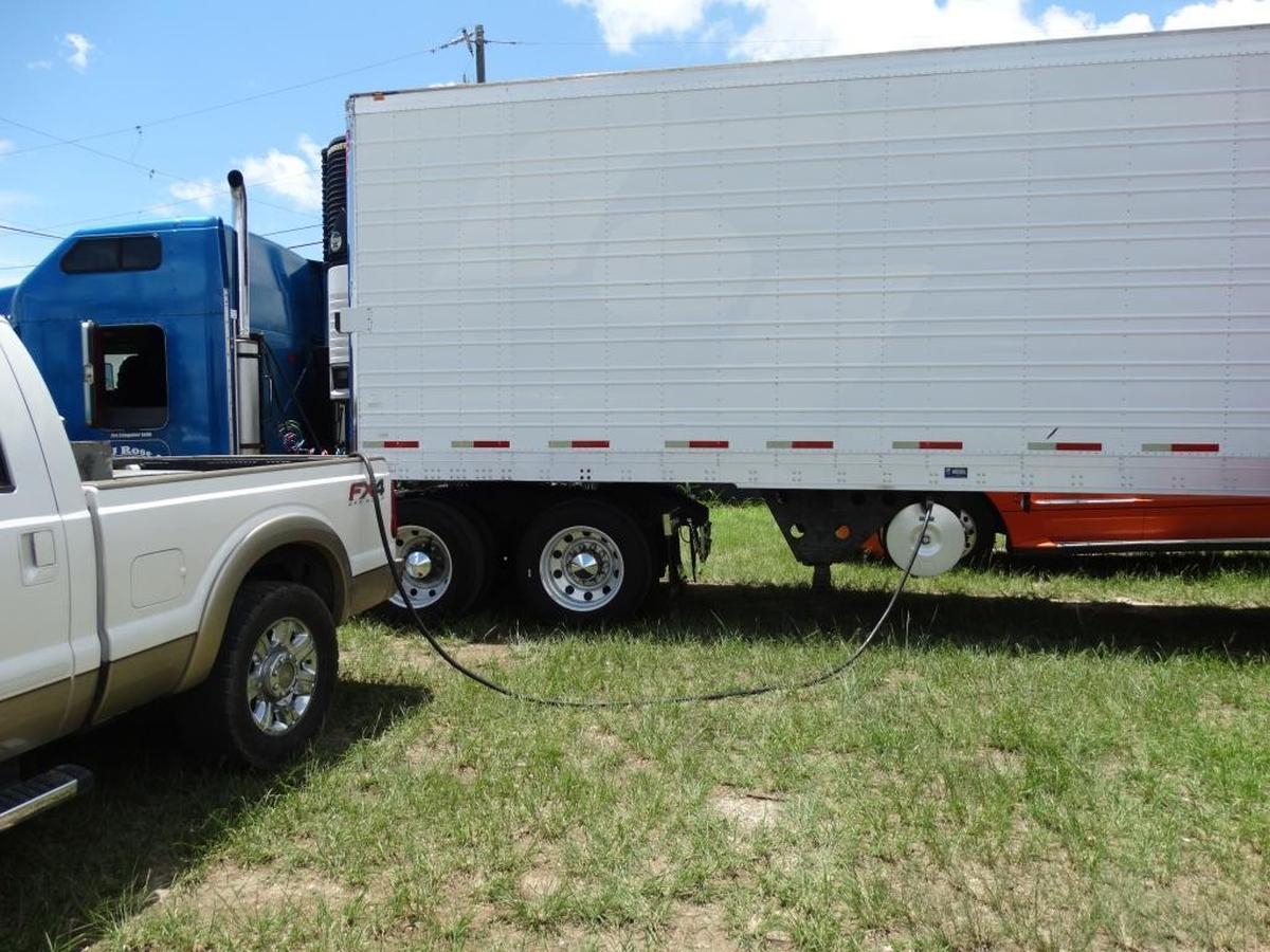 Miami-Dade police photo of a suspected illegal fuel truck gassing up a tractor-trailer truck. The suspect, Damian Martinez-Valdez, is awaiting trial.