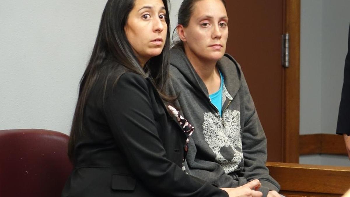 Cristina Hurt, with defense attorney Damaris del Valle, was taken into custody Monday after prosecutors upgraded her charge to second-degree murder.