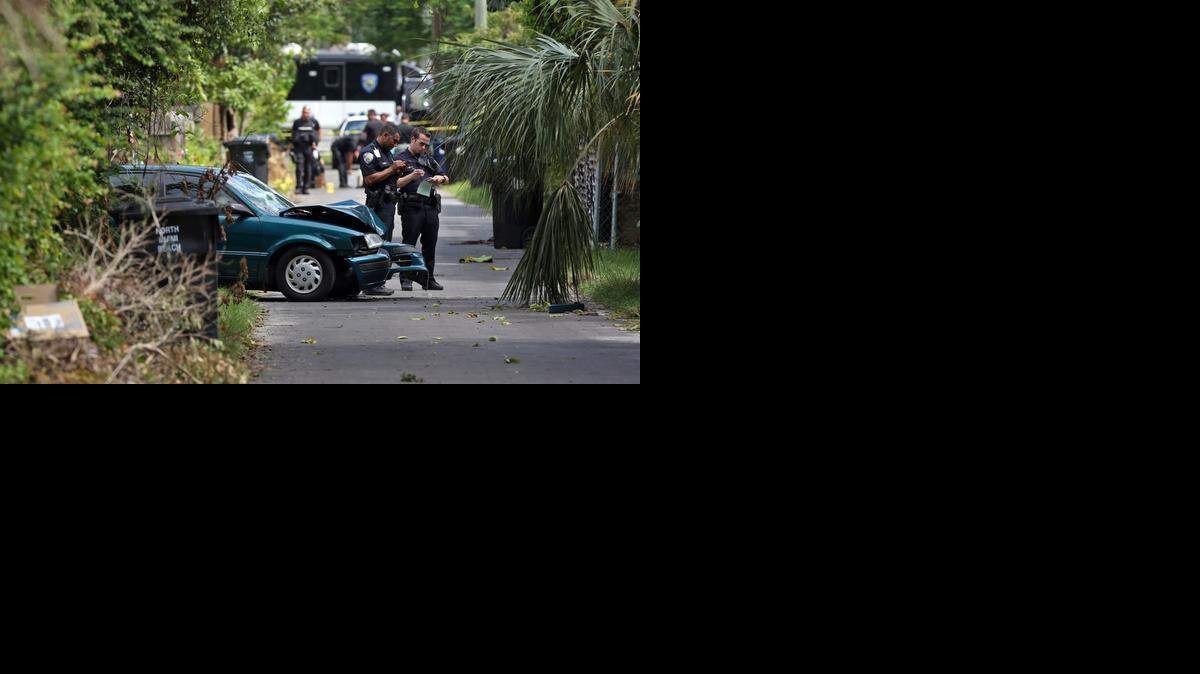 
ON THE SCENE: North Miami Beach police officers investigate a shooting Monday near Northeast 159th Street between 13th and 12th avenues. The injured suspect’s car crashed in an alley after leaving the scene.
