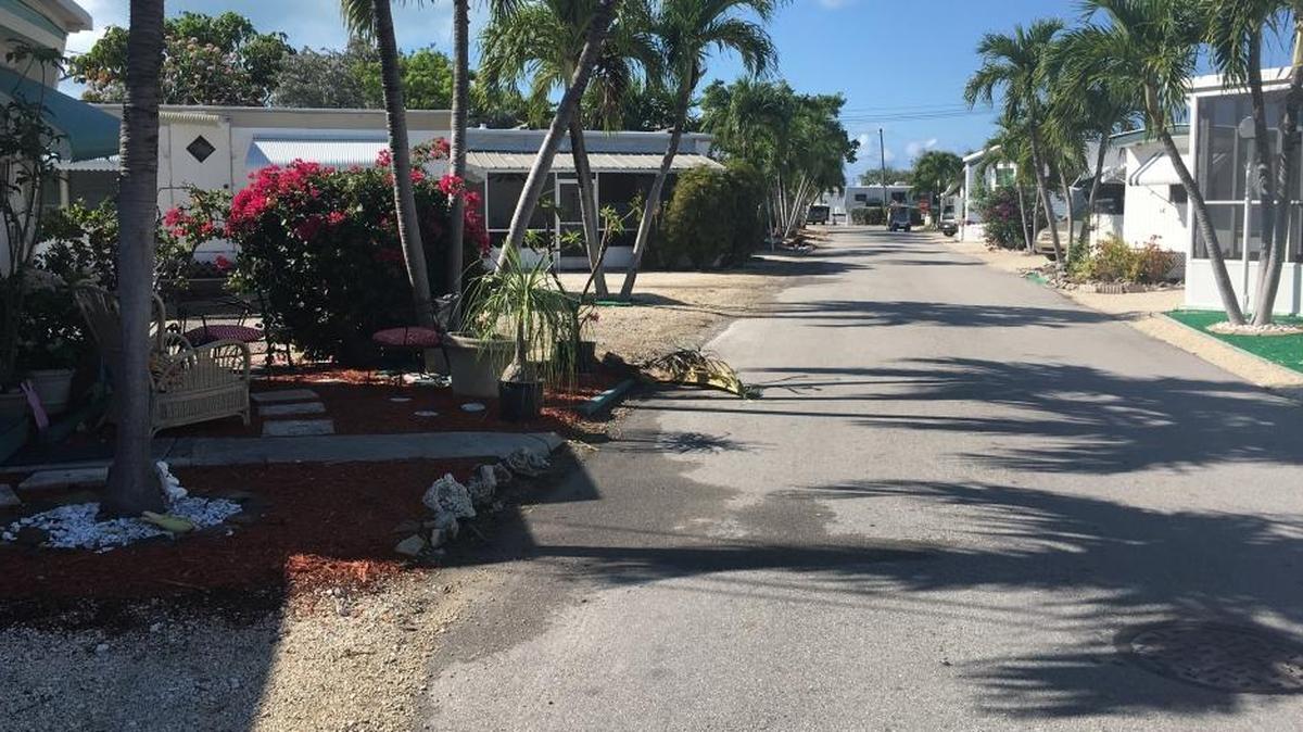 The wet part of the east-side road is where 34-year-old Andre Howard’s body was found in the Key by the Sea condo complex Monday morning.
