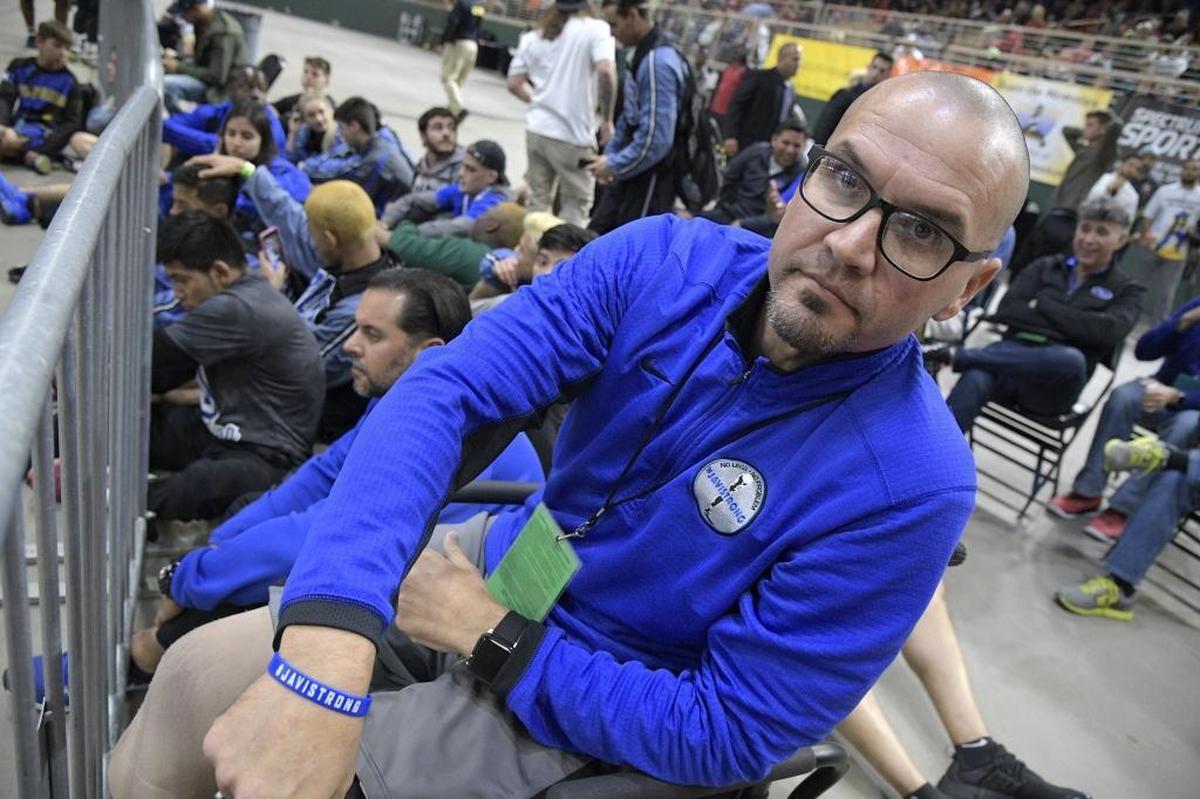 South Dade principal Javier Perez shows his wrist band while watching one of the school's championship matches earlier this year. Perez lost his legs when a suspected drunk driver plowed into him at a baseball field.