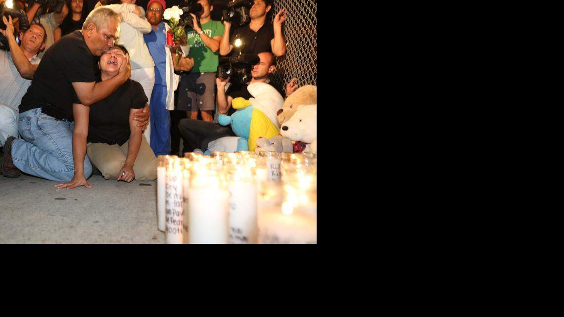 
Marisol Sanchez and Manuel Uriarte mourn their son Pedro Joaquin Uriarte on Monday, Dec. 1, 2014, in front of a makeshift memorial to the teen. Uriarte was gunned down Sunday afternoon near his home, just outside of Paul Laurence Dunbar Elementary School, Northwest 20th Street and Fifth Place.


