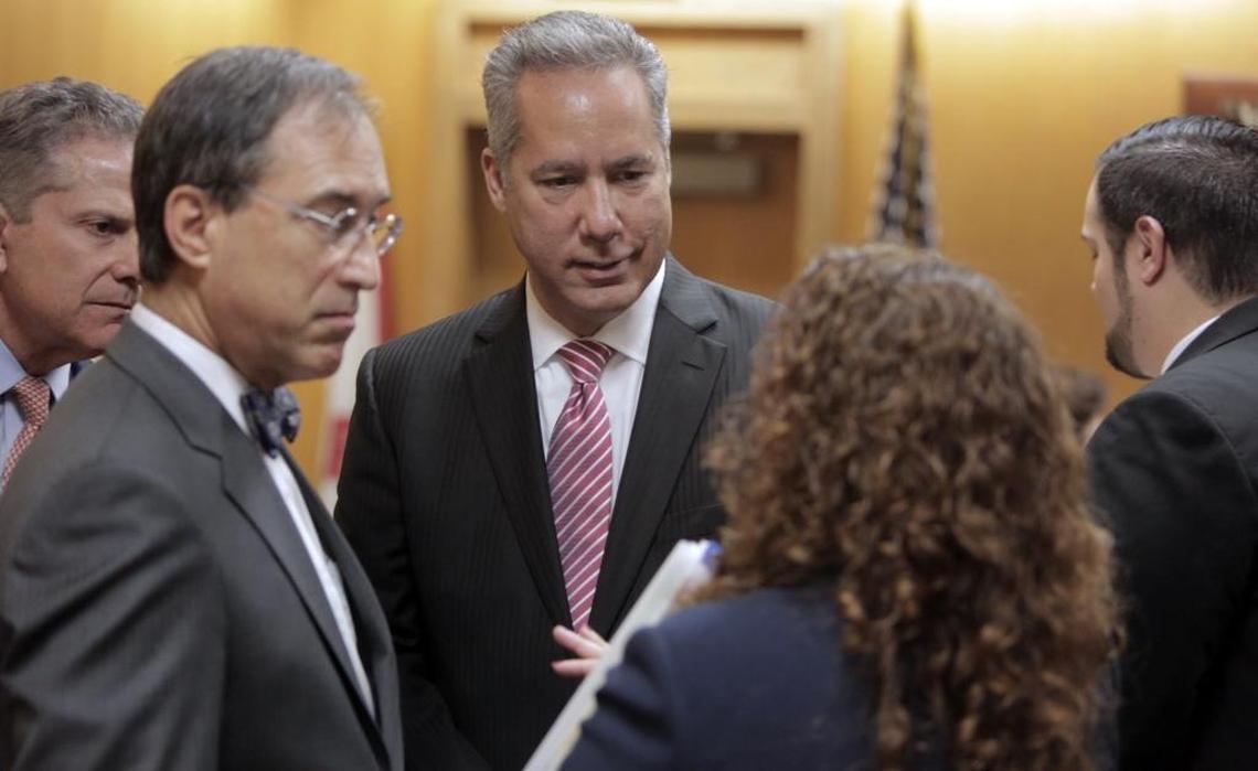 North Miami Beach Mayor George Vallejo, center, with his attorneys in court on Tuesday morning. Vallejo pleaded guilty to a campaign finance violation as part of a plea deal worked out in advance.