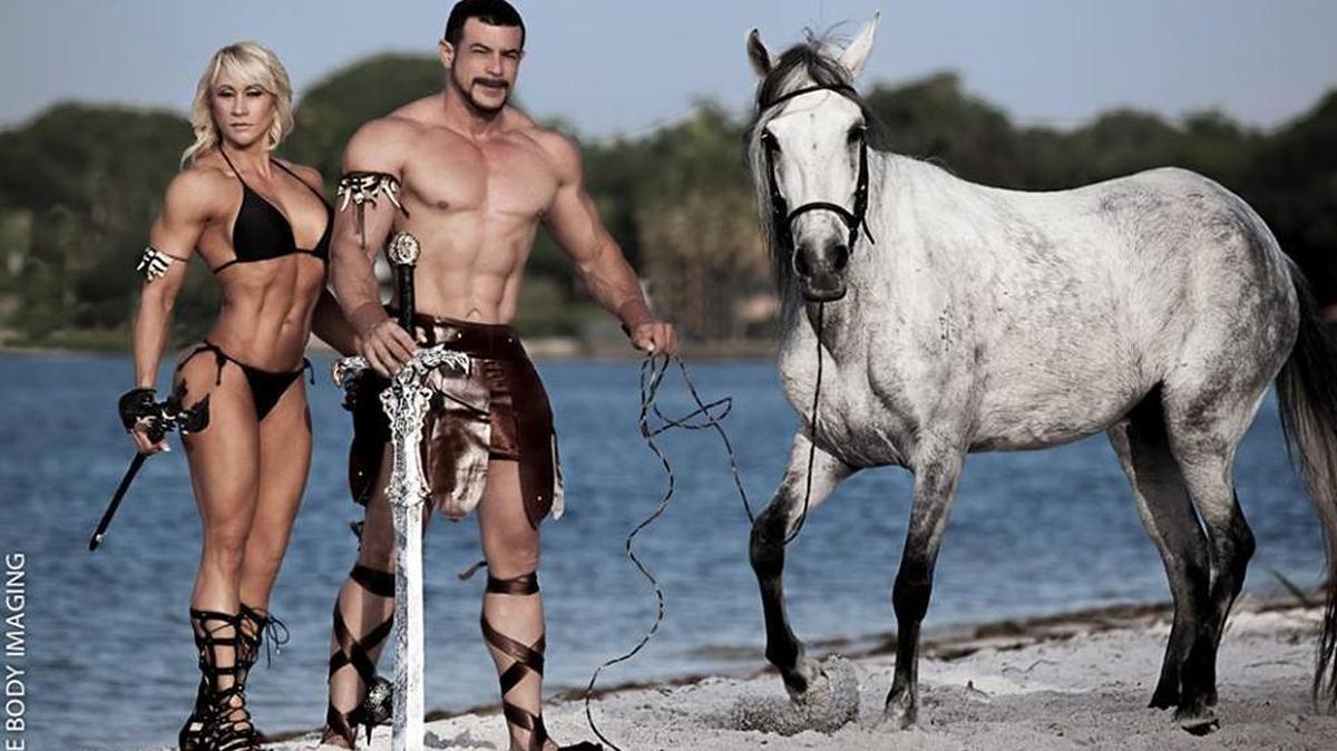 Milly Cowan and Alex Paez, shown here posing with a horse on the beach in 2014, have been charged with misdemeanor charges after the animals were emaciated at their South Miami-Dade ranch.