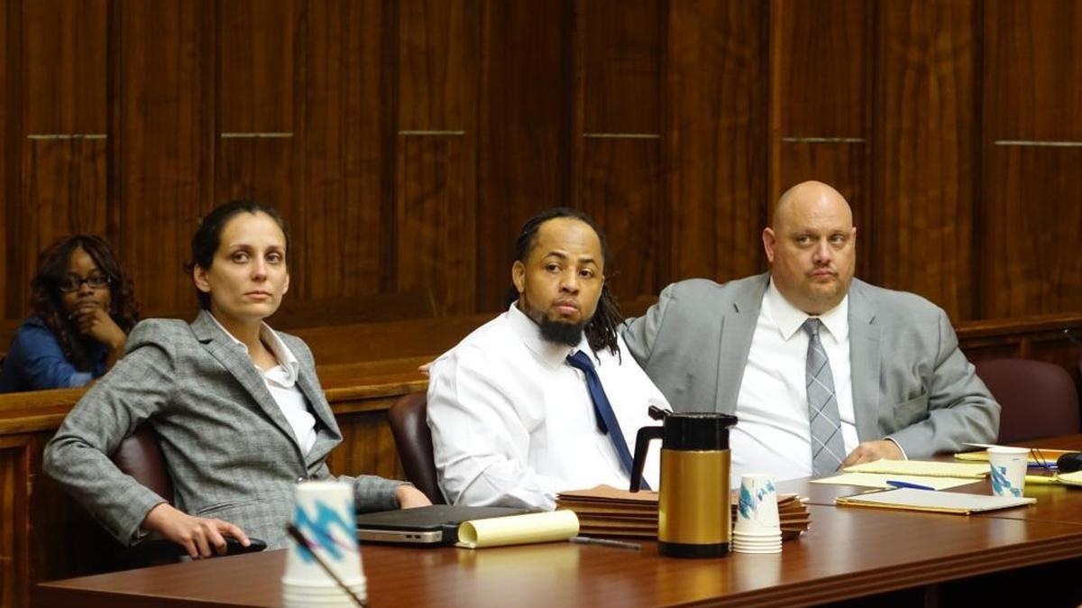 Stevenson Charles, flanked by lawyers Melissa Ortiz and Terry Lenamon, in Miami-Dade court during his trial for murder. On Thursday, a jury convicted Charles of the 2008 slaying of North Miami pawnshop owner Marty Sprung.