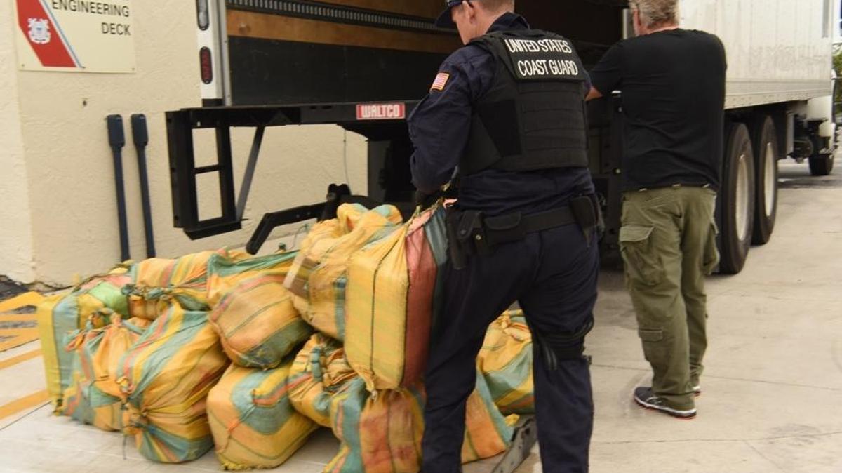 Coast Guard Cutter Valiant crew member offloads a bale of cocaine at Station Fort Lauderdale, Sept. 27, 2017. The drugs were transferred to the Valiant after being interdicted in three separate cases in the Eastern Pacific in September.