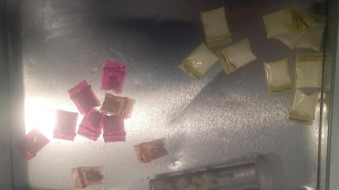 Drugs found by members of the Miami Dade Police Department special response team at several houses during a heroin related drug bust operation in this file photo from December 15, 2016.