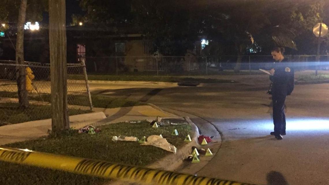 A Miami police officer investigates the scene of a robbery turned shooting around 8 p.m. Saturday in Clemente Park that left three injured, including a 12-year-old boy.