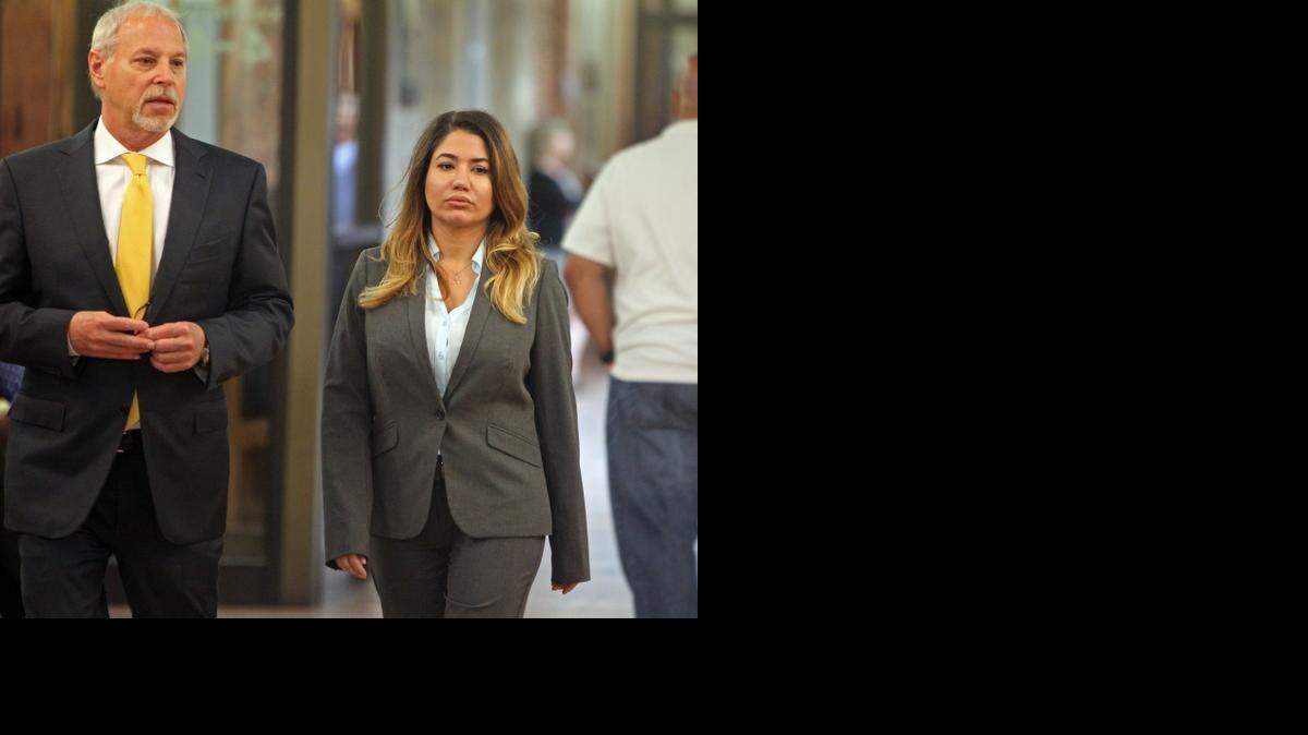
 Attorney Bruce Fleisher, left, walks with client Janespy Carballo, who is accused of murdering a man she believed was her husband's killer.
