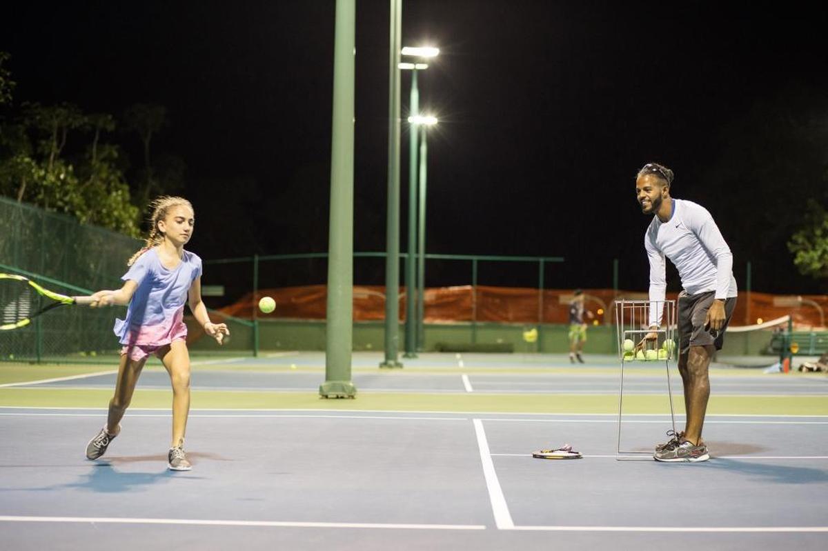 Tennis instructor Osmailer Torres, accused of hitting a 5-year-old, trains his student Nadia Ahmadi at Brickell Bay Club in Miami on Monday, Dec. 4, 2017.