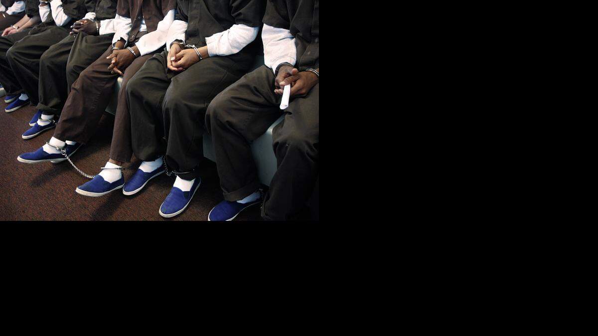 
A group of juvenile inmates sit as they wait to appear in courtroom.
