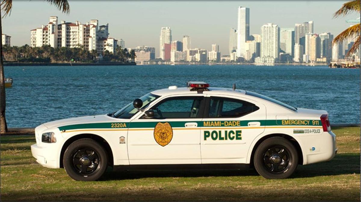 An officer fired from the Miami-Dade police last year for faking a military deployment was arrested Tuesday and charged with official misconduct and grand theft.