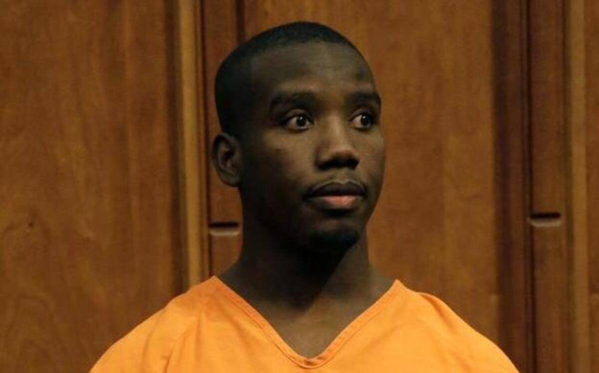 Quentin Wyche stands in court in 2013 to hear his sentence for the killing of an unarmed school football player. On Friday, a judge reduced his sentence from 20.5 years to 11.