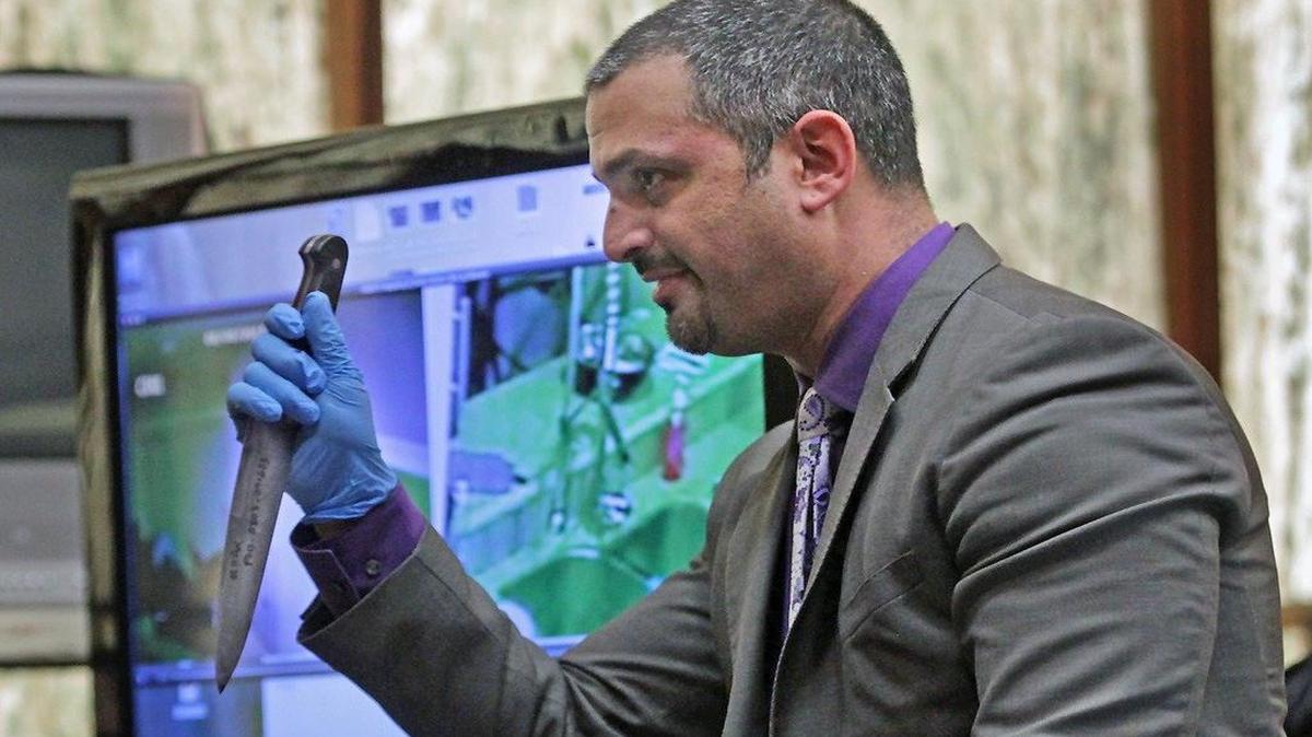 Saam Zangeneh, defense attorney for Derek Medina, holds a knife that was allegedly held by Jennifer Alfonso against Medina during an argument in which Derek Medina shot her to death, during closing arguments to the jury on Tuesday, Nov. 24, 2015