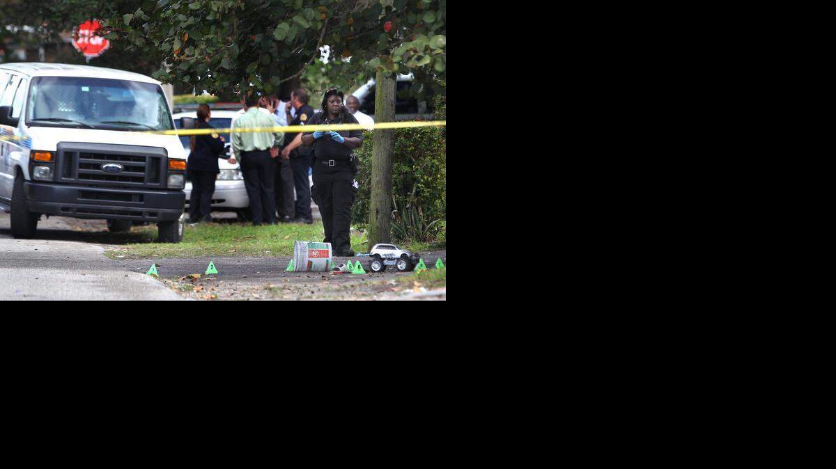 
Investigators work the crime scene where an unidentified male was fatally shot. City of Miami Police responded to this year's first homicide, after an unidentified male was fatally shot several times at the 1400 block of NW 69th Street in the Liberty City neighborhood of Miami on Sunday, January 4, 2015.
