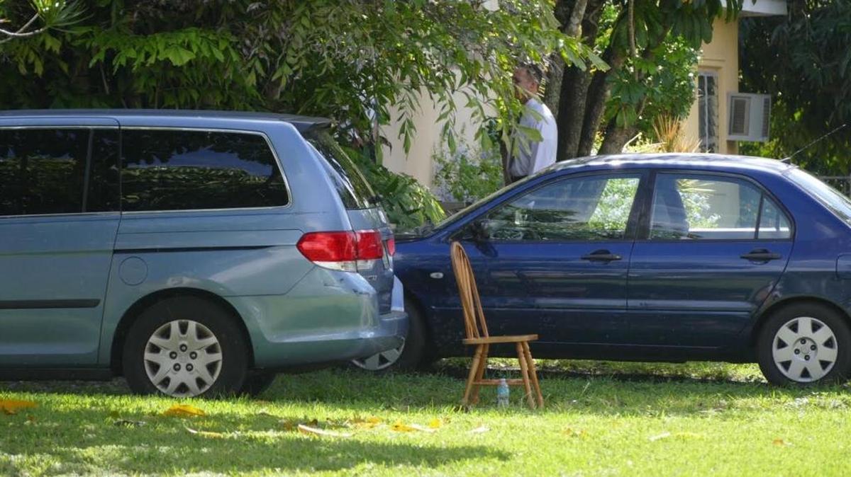 An investigator scours the Westchester property where two men were found dead Monday.