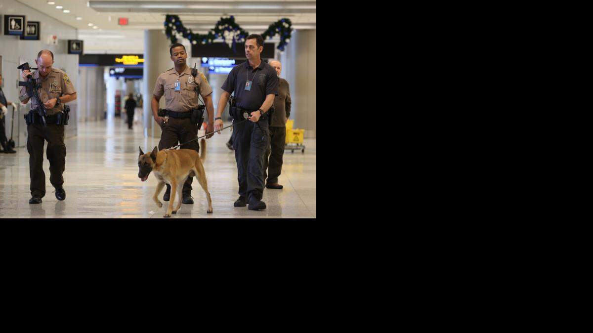 
Miami Dade County police officers patrolling the departures area at Miami International Airport. 

